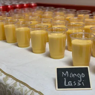 a long table of mango lasss