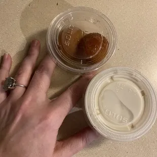 a person's hand holding a cup of coffee