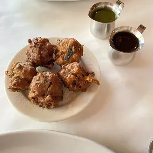 Vegetable Pakoda with spicy mint and tamarind sauces.