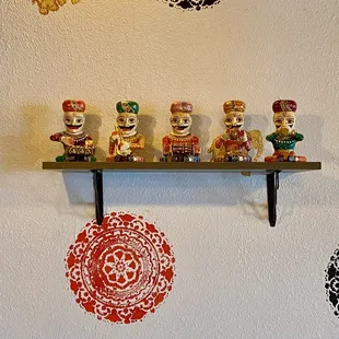 a row of figurines on a shelf