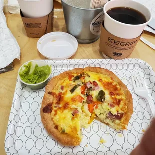 Ham and veggie quiche, with side of avocado spread and a small coffee