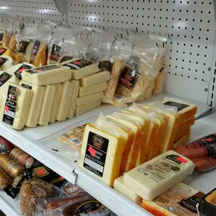cheeses and meats on shelves