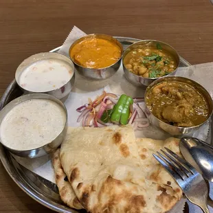Non-veg thali: naan, chicken curry, chickpeas, butter chicken or tikka masala, some kind of yogurt sauce, and i think rice kheer
