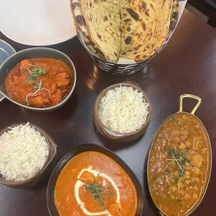Bottom right: CHANA AND ALOO MASALA Bottom middle: CHICKEN TIKKA MASLA Left side: CHICKEN VINDALOO Top middle: BREAD BASKET