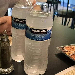 two bottled water bottles on a table