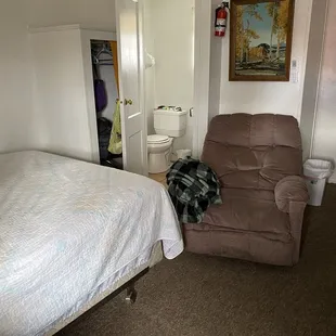 Inside room 5 - queen sized bed and comfy recliner