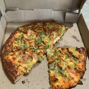 a half eaten pizza in a box