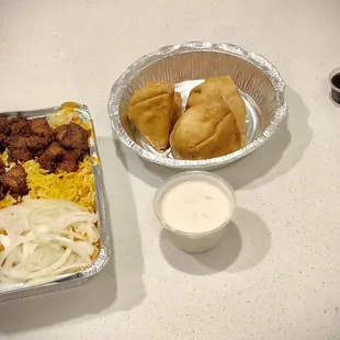 a tray of food and a bowl of dips