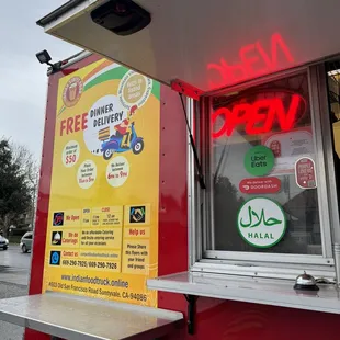 a food truck with a neon sign