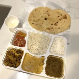 Monday 1.22.24 thali: (clockwise) chapati, jeera rice, raita, daal tadka, malai kofta, veg &amp; paneer, veg pickles, maybe rasgulla