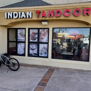 a bicycle parked in front of a restaurant