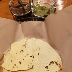 Almost like a seasoned cracker they serve with a sweet chili type sauce and a green chili sauce. Think of it like a chips/salsa. :-)