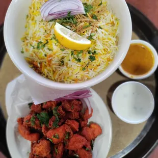 a bowl of rice and a plate of meat