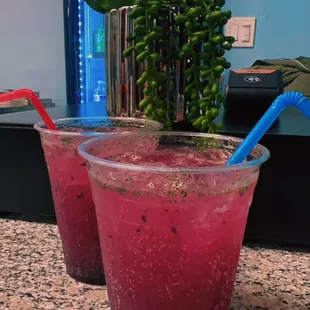 a close up of two glasses of juice