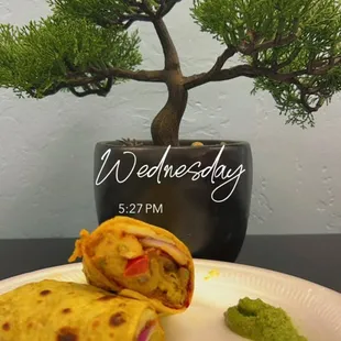 a plate of food and a bonsai tree