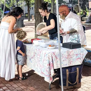 a woman serving food to a child