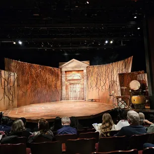 a stage with a stage set and a stage curtain