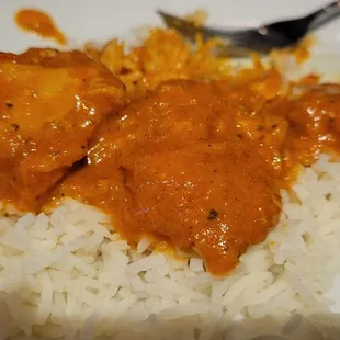 a plate of rice and chicken curry