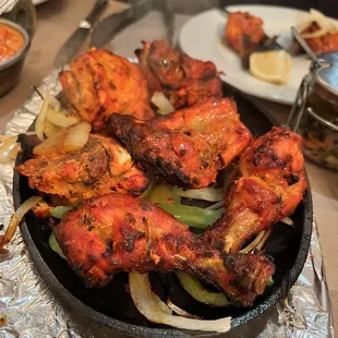 a plate of chicken wings and vegetables