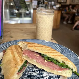 a sandwich on a blue and white plate