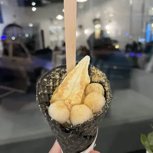 a person holding a cone of food