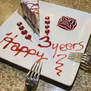 a piece of cake on a plate with the words happy birthday written on it