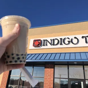 a hand holding a cup of coffee