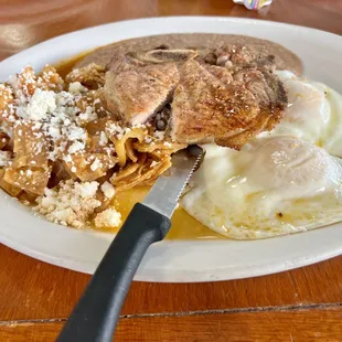 Chuletas and chilaquiles breakfast plate