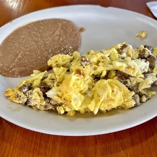 American breakfast plate - Sausage, eggs and refried beans