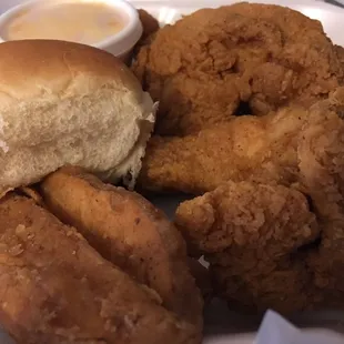 Three oc dinner box with wedges hiding under a fried chicken blanket.