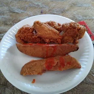 Hot wings with potato wedges. Added hot sauce to the wedges.so good