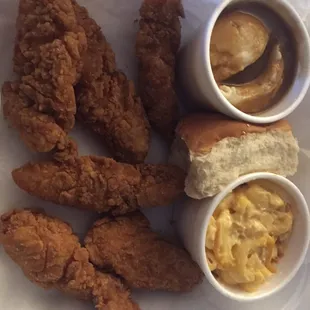 Chicken finger basket with mashed potatoes and gravy, mac-n-cheese, and a roll.