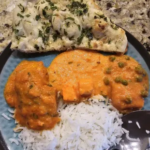 Takeout: garlic naan, butter salmon, paneer tikka masala, aloo mattar,  basmati rice
