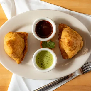 a plate of food with dipping sauce