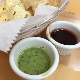 Homemade papadum with turmeric and cilantro dipping sauces.