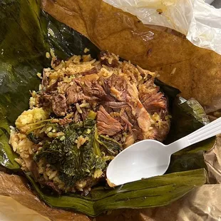 a plate of food with rice, meat and vegetables