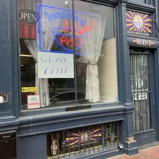 a storefront with a sign in the window
