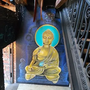 a painting of a buddha on a wall