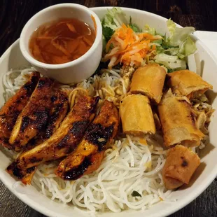 Chicken and egg roll over rice vermicelli.