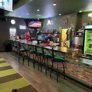 Full bar with plenty of seating. Multiple TV's