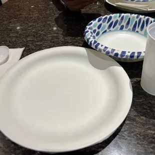 a table with plates, cups, and utensils