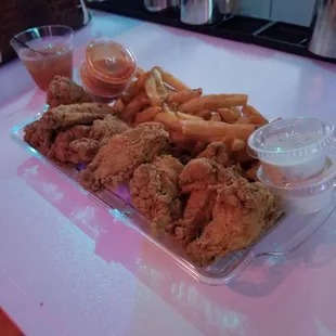 a tray of fried chicken and french fries