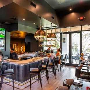 The interior of Indulge Wine Bar features several intimate settings, space for small parties, &amp; a bar top to catch all the action.