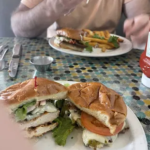 My plate features half each grilled and crispy chicken hanging off the large fresh baked buns