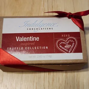 a chocolate bar wrapped in red ribbon