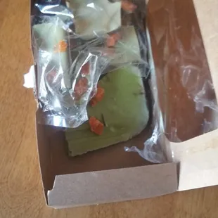 a hand holding a piece of cake