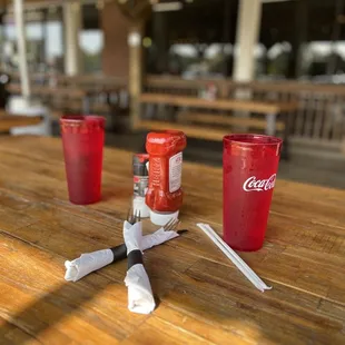 a table with a red cup and a knife