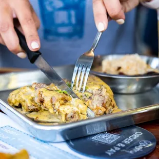a person cutting food with a knife
