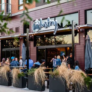 a group of people sitting outside a restaurant