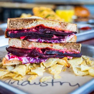 a grilled sandwich and chips